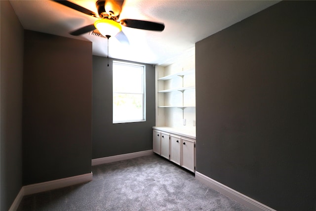 interior space with light carpet and ceiling fan