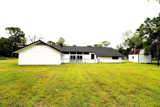 back of property featuring a lawn