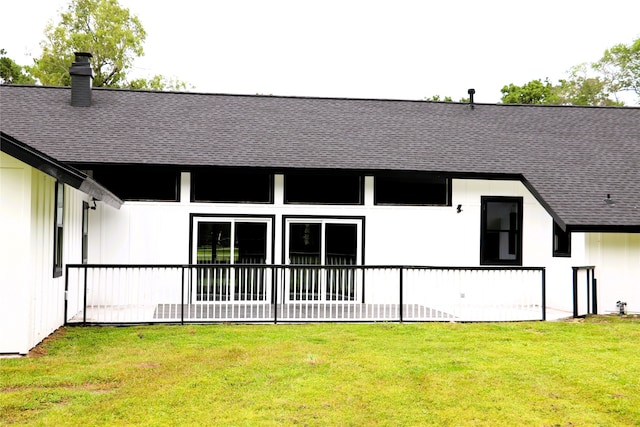 rear view of house with a yard