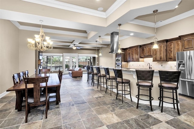 kitchen featuring dark brown cabinetry, a spacious island, appliances with stainless steel finishes, island exhaust hood, and a kitchen breakfast bar