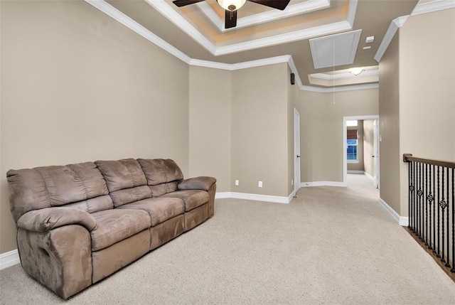 carpeted living room featuring ceiling fan, a raised ceiling, and ornamental molding