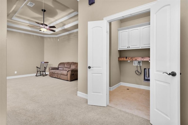 laundry room with ceiling fan, light carpet, and ornamental molding