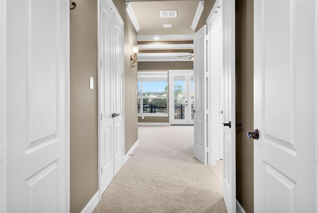 corridor featuring light colored carpet