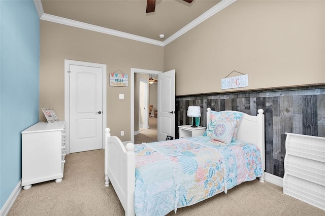 carpeted bedroom featuring ornamental molding and ceiling fan