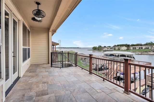 balcony featuring a water view and a patio area