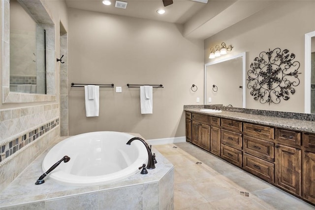 bathroom with vanity and shower with separate bathtub