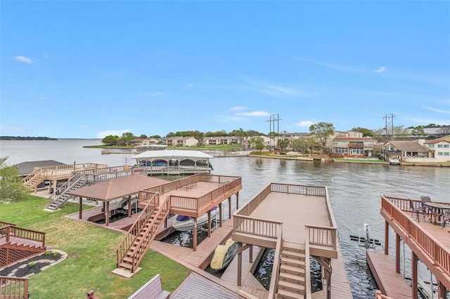 dock area featuring a yard and a deck with water view