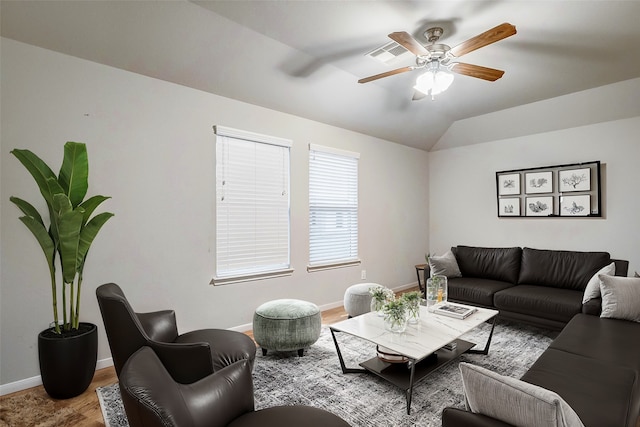 living room featuring ceiling fan, hardwood / wood-style floors, and lofted ceiling