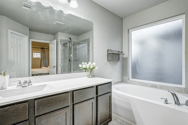 bathroom featuring tile patterned flooring, vanity, and independent shower and bath