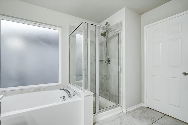 bathroom featuring tile patterned floors and separate shower and tub