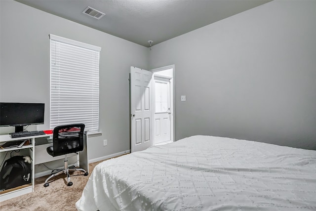 bedroom with light colored carpet