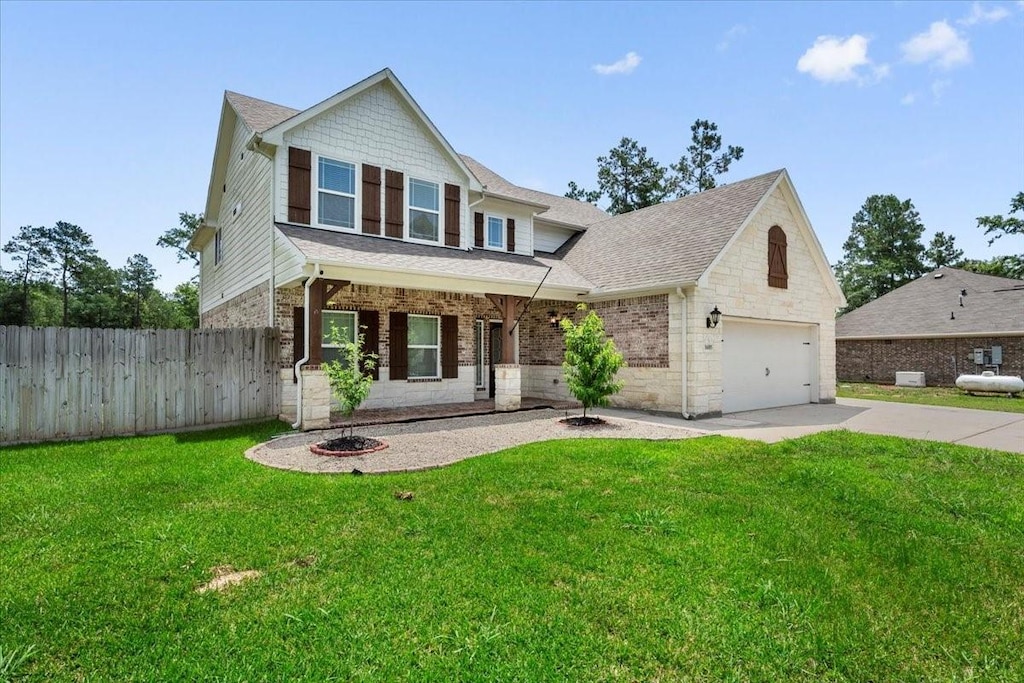 16085 Deer Pines Dr, Conroe, TX 77303 - traditional-style house featuring a garage, stone siding, roof with shingles, concrete driveway, and fence