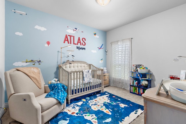 bedroom with carpet and a nursery area