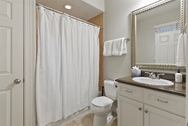 bathroom featuring vanity, a textured ceiling, walk in shower, tile patterned flooring, and toilet