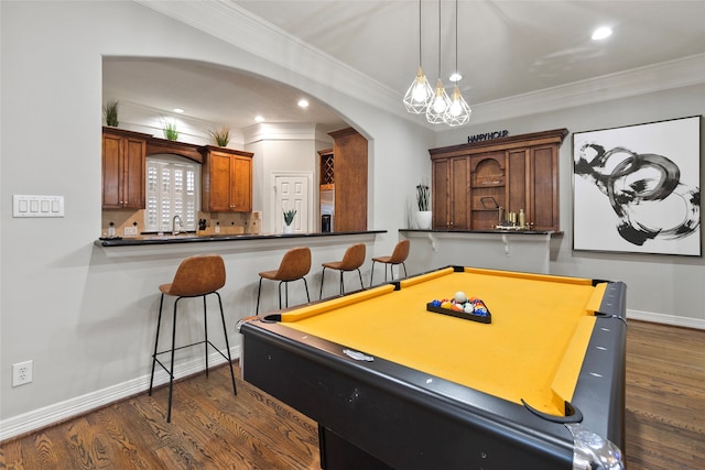 rec room with ornamental molding, dark wood-type flooring, and billiards