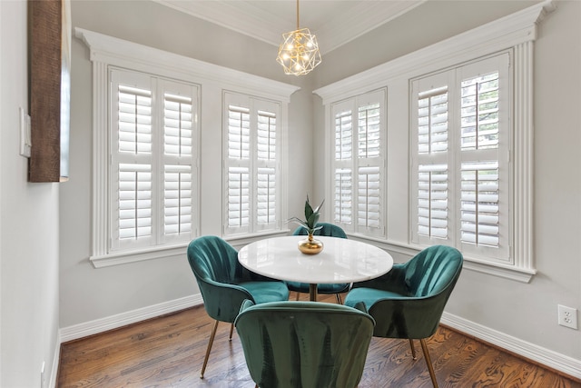 dining area featuring ornamental molding and dark wood-type flooring