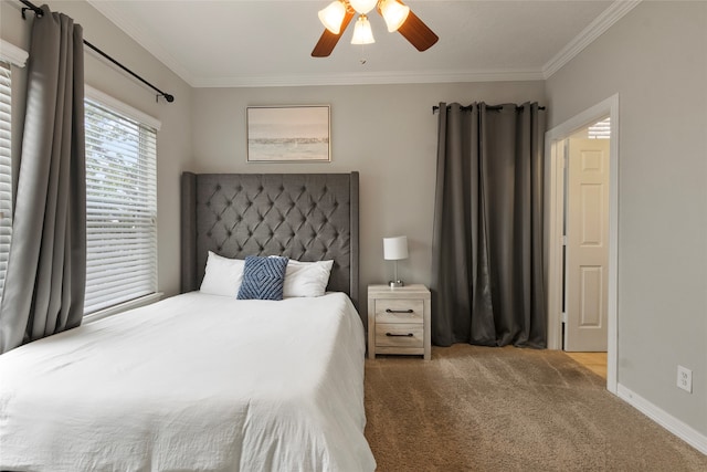 carpeted bedroom with ceiling fan and crown molding