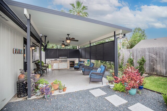 view of patio with area for grilling and ceiling fan