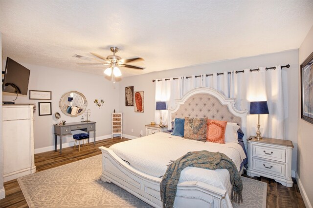 bedroom featuring ceiling fan, dark hardwood / wood-style flooring, and a textured ceiling