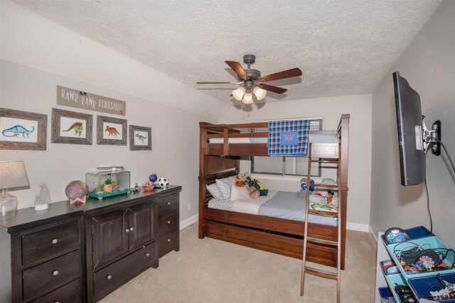 carpeted bedroom with a textured ceiling and ceiling fan