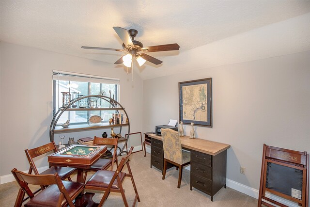 office featuring light carpet, ceiling fan, and a textured ceiling