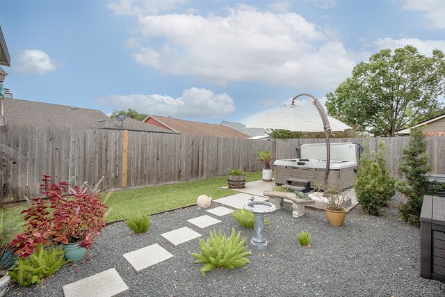 view of yard featuring a patio and a hot tub