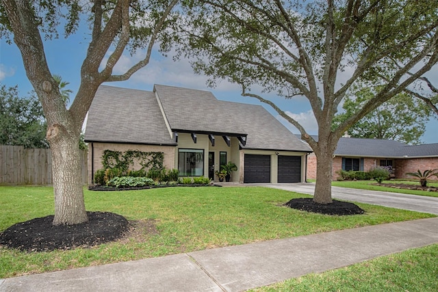 view of front of property featuring a garage and a front lawn