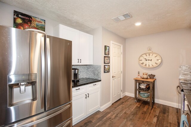 kitchen with dark stone countertops, stainless steel fridge with ice dispenser, dark hardwood / wood-style flooring, and white cabinets