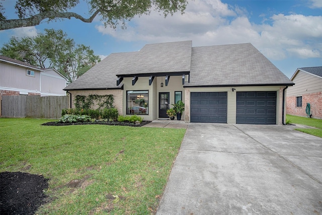 view of front of home with a front yard and a garage