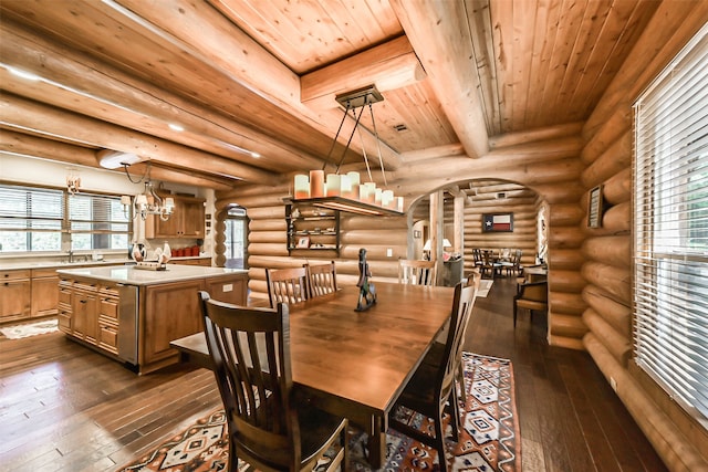 dining space with rustic walls and dark hardwood / wood-style flooring