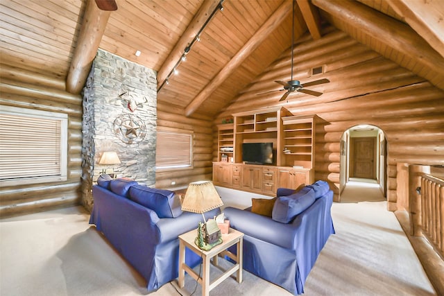 carpeted living room with log walls, wood ceiling, and rail lighting