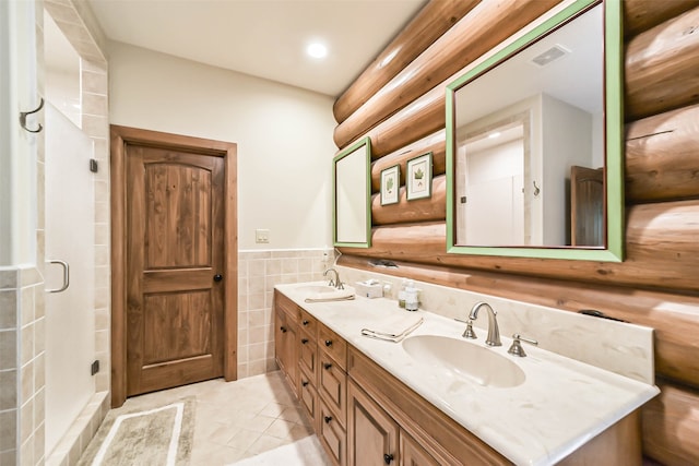 bathroom featuring vanity, tile walls, and an enclosed shower