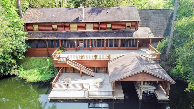 back of house featuring a deck with water view