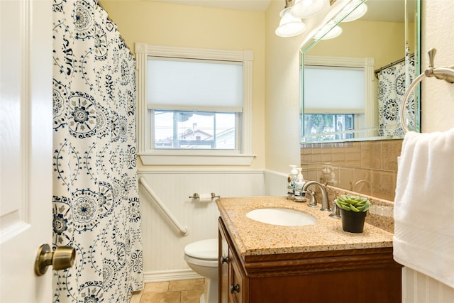 bathroom featuring tile patterned flooring, vanity, and toilet