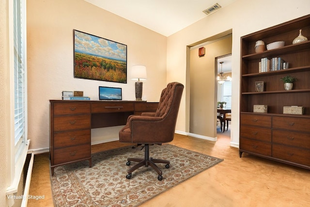 home office with a notable chandelier