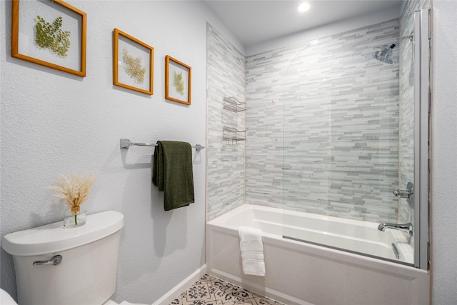 bathroom with toilet, tile patterned flooring, and tiled shower / bath