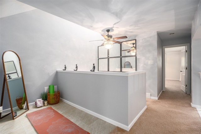 interior space featuring light carpet and sink