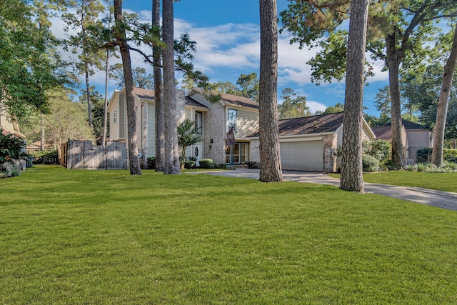 view of front of property featuring a front yard and a garage