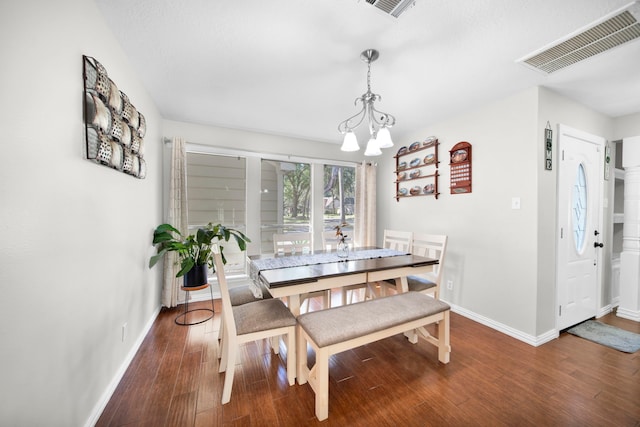 dining room with wood-type flooring and a notable chandelier