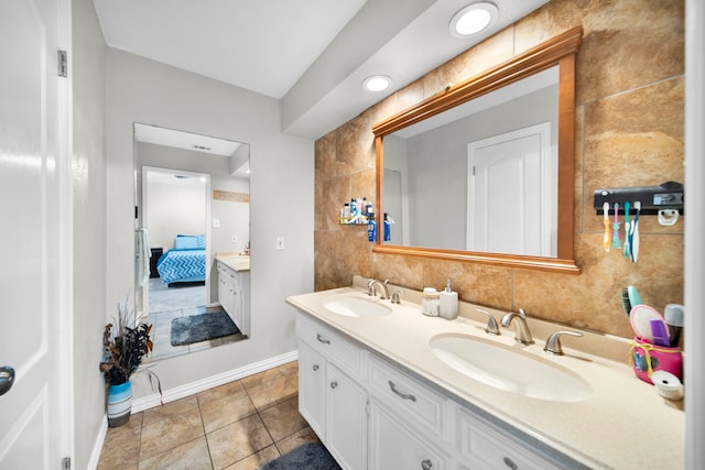 bathroom with vanity, tile walls, and tile patterned flooring