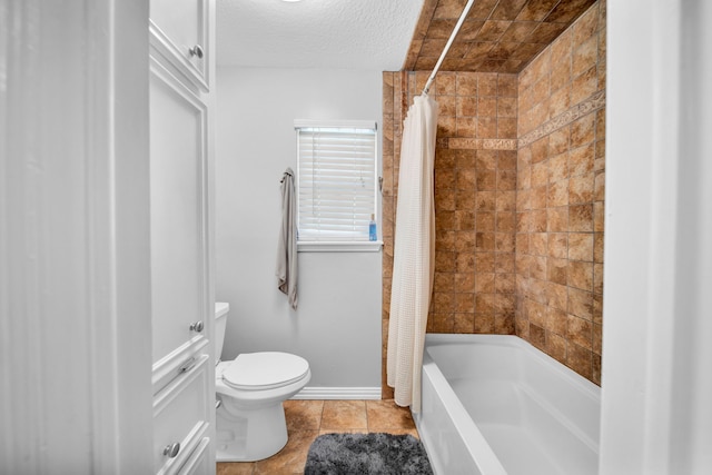 bathroom with a textured ceiling, shower / tub combo, tile patterned flooring, and toilet