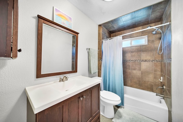 full bathroom featuring a textured ceiling, shower / tub combo, vanity, and toilet