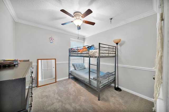 bedroom featuring a textured ceiling, ceiling fan, carpet floors, and crown molding