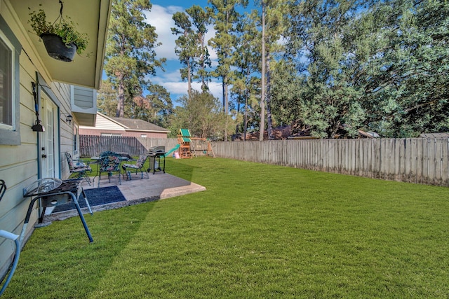 view of yard with a playground and a patio area