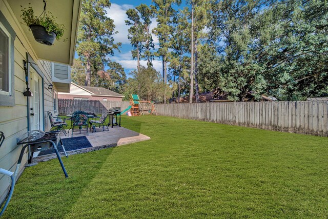 15010 Rolling Oaks Dr, Houston, TX 77070 - view of yard with a fenced backyard, a patio area, and a playground