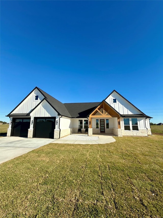 view of front of home with a front yard and a garage