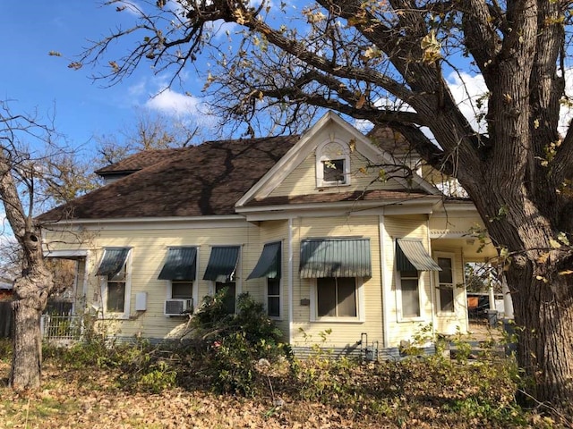 rear view of property with cooling unit