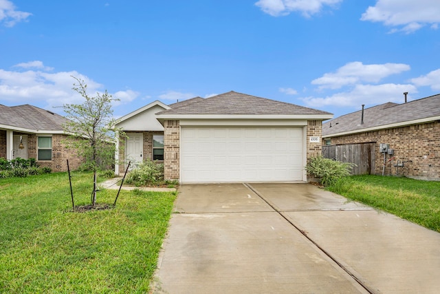 ranch-style house featuring a front yard and a garage