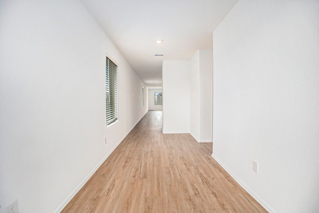 hallway with light hardwood / wood-style floors