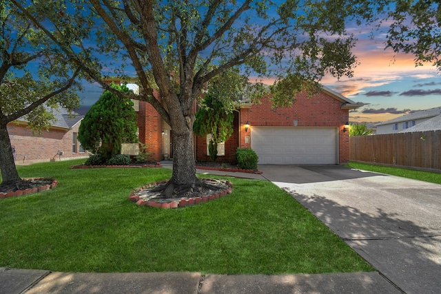 view of front of home with a yard and a garage